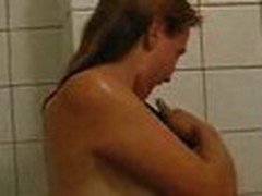 Girlie doesn't shy to be filmed on camera naked. That babe proceeds showering, when her guy enters bathroom.